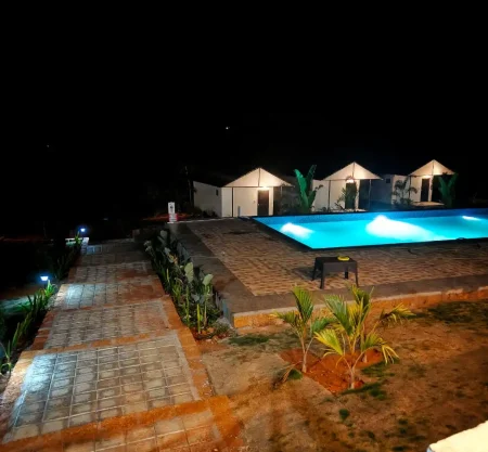 Himabindu Plantation Homestay Sakleshpur swimming pool and cottages at night