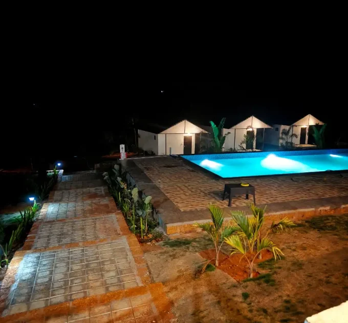 Himabindu Plantation Homestay Sakleshpur swimming pool and cottages at night